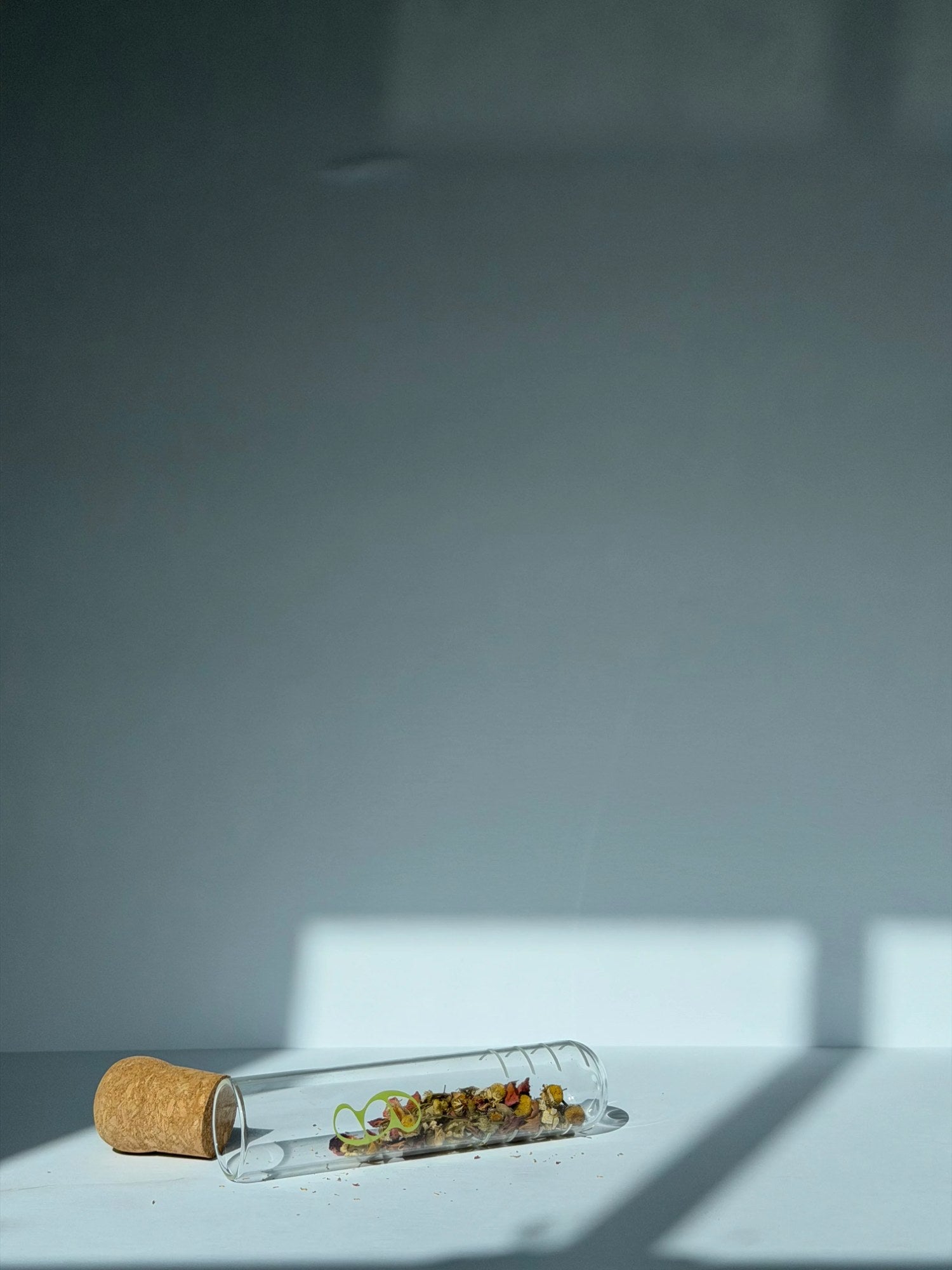 Glass herb infuser open showing interior capacity for whole-leaf botanicals