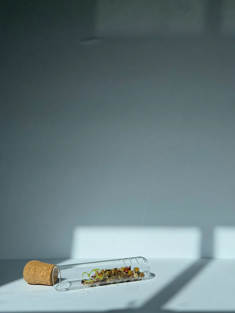 Glass herb infuser open showing interior capacity for whole-leaf botanicals